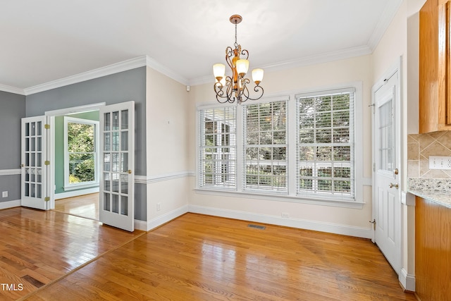 6201 King Croydon Ct, Raleigh, NC 27603 - unfurnished dining area featuring healthy amount of natural light, light wood-type flooring, and crown molding