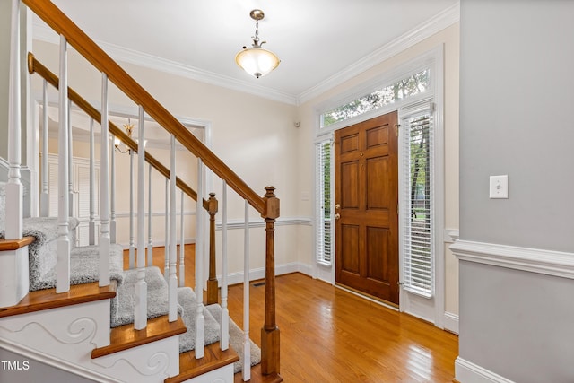 6201 King Croydon Ct, Raleigh, NC 27603 - entrance foyer with stairs, wood finished floors, and ornamental molding