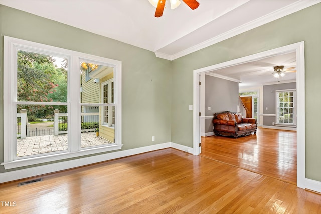 6201 King Croydon Ct, Raleigh, NC 27603 - unfurnished living room featuring a ceiling fan, ornamental molding, and wood finished floors