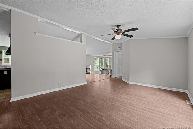 spare room with ceiling fan, a textured ceiling, wood finished floors, ornamental molding, and baseboards