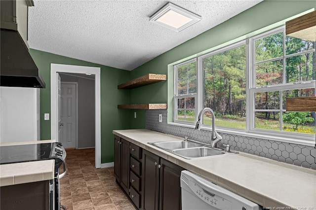 kitchen with a sink, electric stove, wall chimney range hood, dishwasher, and light countertops