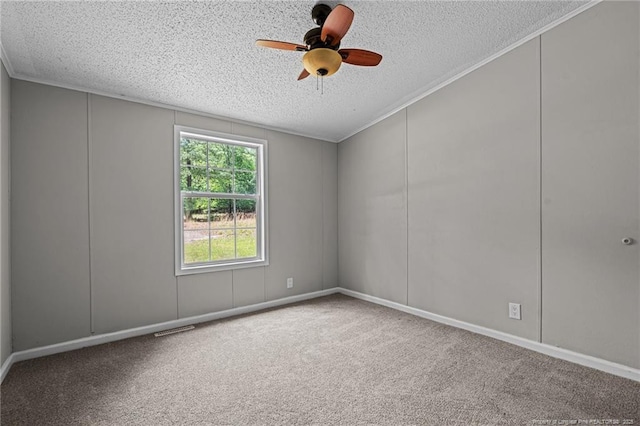carpeted spare room featuring a textured ceiling and ceiling fan