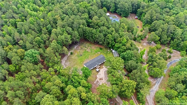 aerial view of property's location featuring a forest