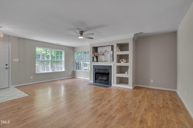 314 Virens Dr, Cary, NC 27511 - unfurnished living room with a ceiling fan, light wood-style flooring, built in features, a fireplace with flush hearth, and baseboards