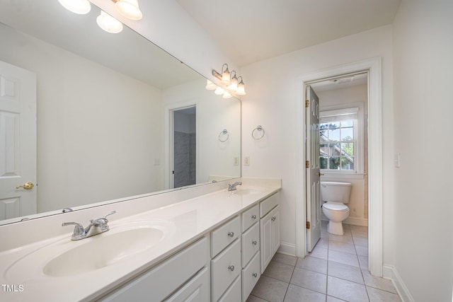 full bath featuring double vanity, tile patterned flooring, baseboards, and toilet