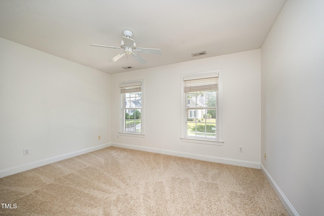 unfurnished room with light carpet, baseboards, and ceiling fan