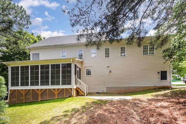 back of house with a sunroom, crawl space, and a lawn