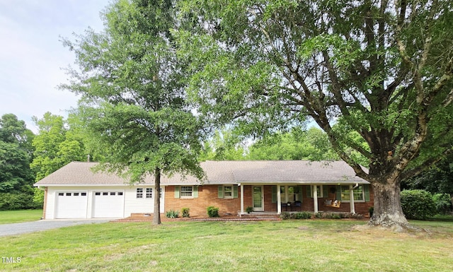 3669 W Greensboro Chapel Hill Rd, Liberty, NC 27298 - ranch-style home featuring covered porch, an attached garage, asphalt driveway, and a front lawn