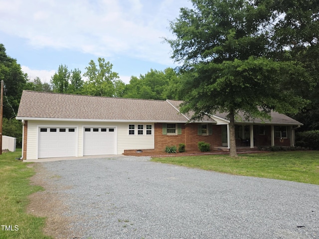 3669 W Greensboro Chapel Hill Rd, Liberty, NC 27298 - single story home with gravel driveway, a garage, a front lawn, and covered porch