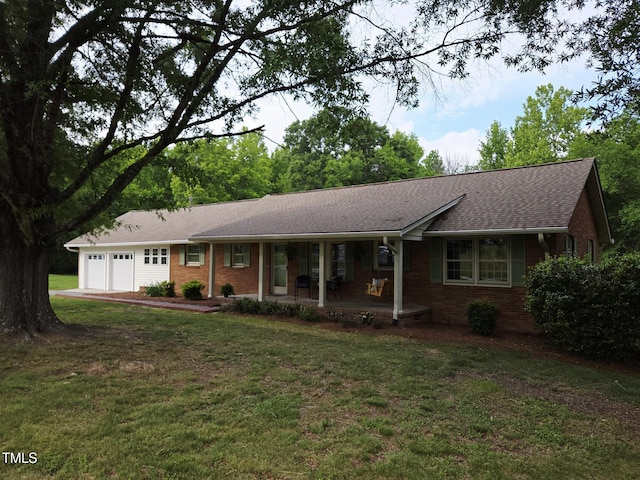 3669 W Greensboro Chapel Hill Rd, Liberty, NC 27298 - ranch-style home featuring a porch, brick siding, an attached garage, a front yard, and a shingled roof