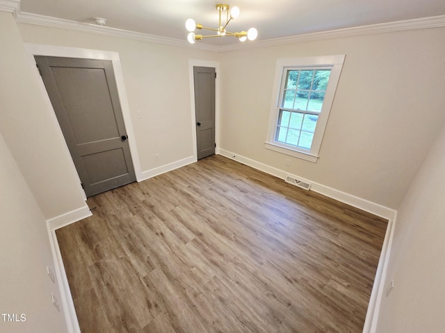 3669 W Greensboro Chapel Hill Rd, Liberty, NC 27298 - unfurnished room with a chandelier, ornamental molding, wood finished floors, baseboards, and a smoke detector