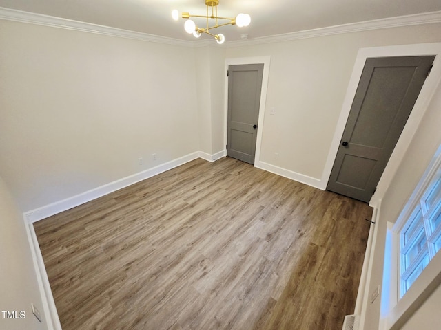 3669 W Greensboro Chapel Hill Rd, Liberty, NC 27298 - spare room featuring wood finished floors, crown molding, a chandelier, and baseboards