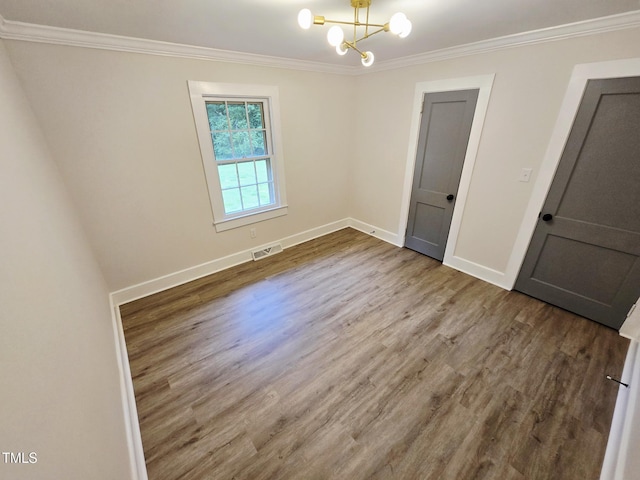 3669 W Greensboro Chapel Hill Rd, Liberty, NC 27298 - empty room featuring ornamental molding, wood finished floors, a chandelier, and baseboards