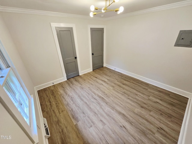 3669 W Greensboro Chapel Hill Rd, Liberty, NC 27298 - empty room with a chandelier, ornamental molding, electric panel, wood finished floors, and baseboards