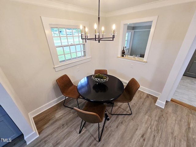 3669 W Greensboro Chapel Hill Rd, Liberty, NC 27298 - dining area featuring baseboards, a chandelier, wood finished floors, and crown molding