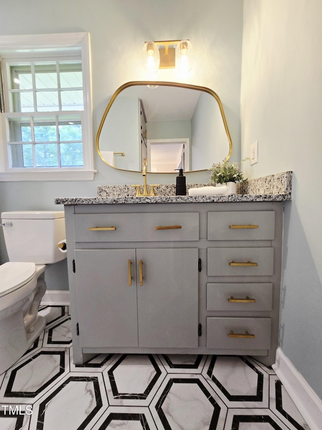 3669 W Greensboro Chapel Hill Rd, Liberty, NC 27298 - bathroom featuring baseboards, vanity, toilet, and inlaid floor details