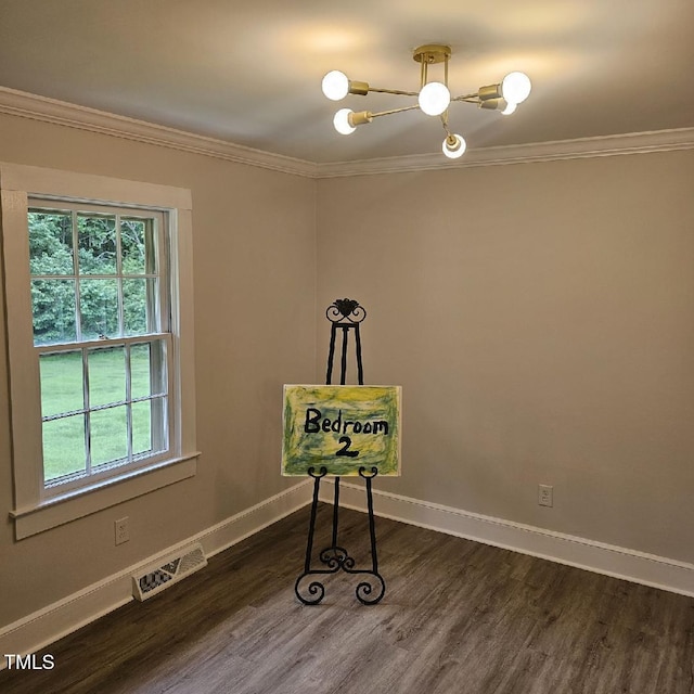 3669 W Greensboro Chapel Hill Rd, Liberty, NC 27298 - spare room featuring ornamental molding, a chandelier, baseboards, and dark wood-style flooring