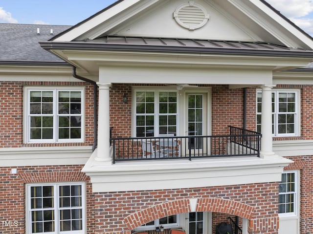 340 Allister Dr Unit 301, Raleigh, NC 27609 - view of home's exterior with a balcony, brick siding, a standing seam roof, and metal roof