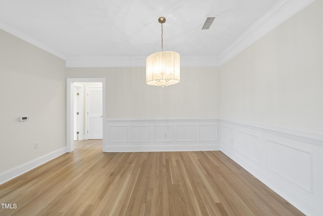 340 Allister Dr Unit 301, Raleigh, NC 27609 - spare room with a chandelier, light wood finished floors, a wainscoted wall, and ornamental molding