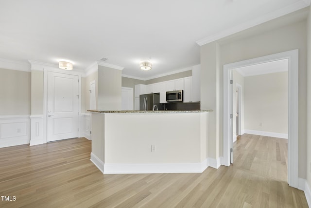 340 Allister Dr Unit 301, Raleigh, NC 27609 - kitchen featuring stainless steel appliances, light wood-style flooring, white cabinets, stone counters, and crown molding