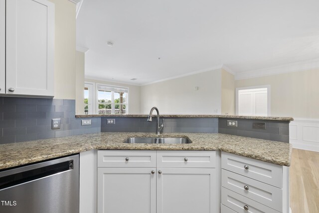 340 Allister Dr Unit 301, Raleigh, NC 27609 - kitchen with stainless steel dishwasher, a sink, crown molding, light stone countertops, and white cabinets