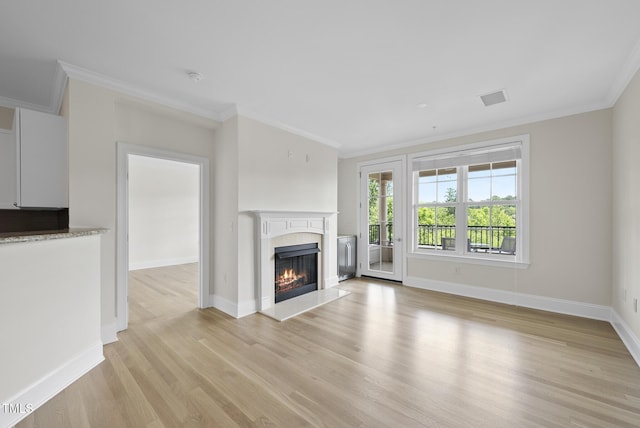 340 Allister Dr Unit 301, Raleigh, NC 27609 - unfurnished living room with ornamental molding, light wood-style floors, a premium fireplace, and baseboards