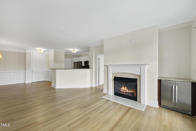 340 Allister Dr Unit 301, Raleigh, NC 27609 - unfurnished living room with crown molding, light wood-style floors, and a premium fireplace