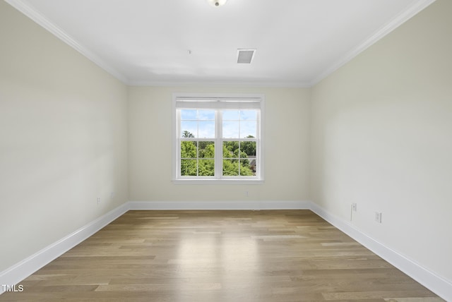340 Allister Dr Unit 301, Raleigh, NC 27609 - unfurnished room with crown molding, baseboards, and light wood-style floors