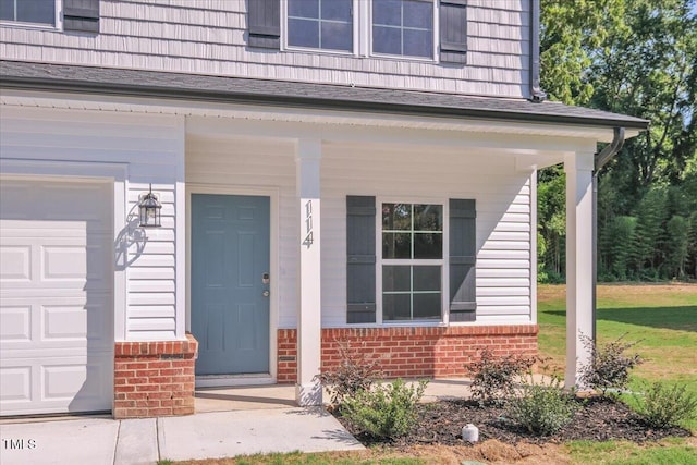 114 Hays St, Oxford, NC 27565 - property entrance with a garage, brick siding, covered porch, and roof with shingles