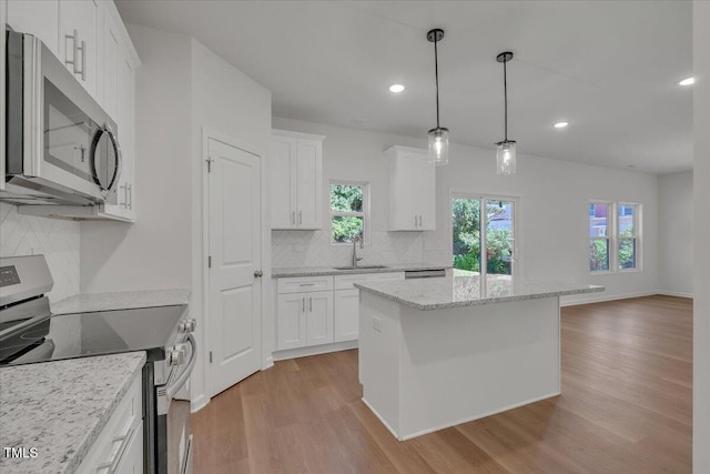 114 Hays St, Oxford, NC 27565 - kitchen featuring stainless steel appliances, light wood finished floors, decorative backsplash, plenty of natural light, and recessed lighting