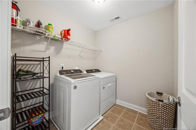 clothes washing area featuring washer and dryer and baseboards