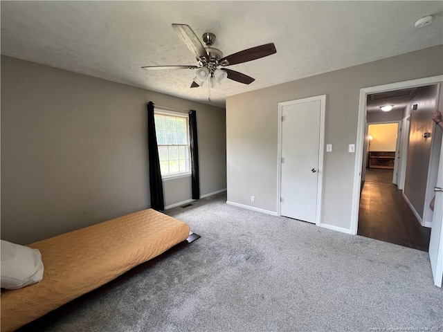 bedroom with carpet flooring, baseboards, and ceiling fan