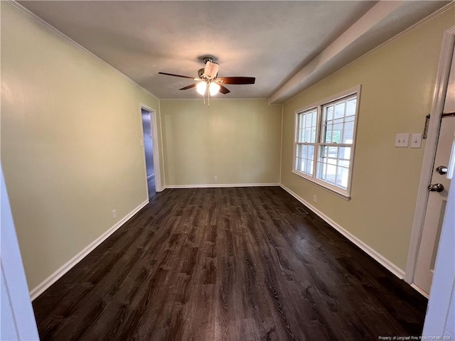unfurnished room featuring dark wood-style flooring, a ceiling fan, and baseboards