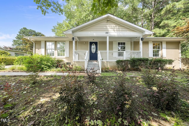 1201 Pond St, Cary, NC 27511 - view of front of home featuring covered porch and brick siding
