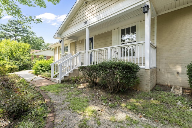 1201 Pond St, Cary, NC 27511 - view of exterior entry featuring covered porch and brick siding