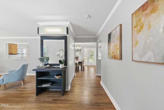 1201 Pond St, Cary, NC 27511 - hall featuring crown molding, wood finished floors, and a chandelier
