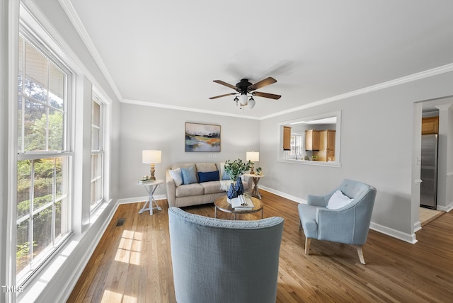1201 Pond St, Cary, NC 27511 - living area featuring a ceiling fan, ornamental molding, and wood finished floors