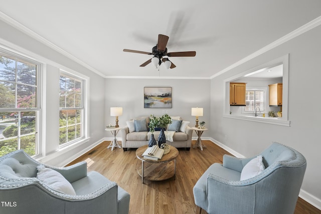 1201 Pond St, Cary, NC 27511 - living room featuring a ceiling fan, ornamental molding, and wood finished floors