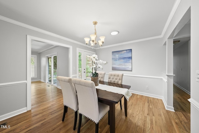 1201 Pond St, Cary, NC 27511 - dining area featuring a chandelier, wood finished floors, crown molding, and recessed lighting