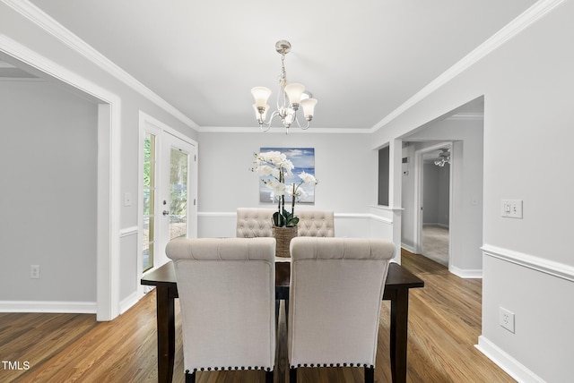 1201 Pond St, Cary, NC 27511 - dining area with a chandelier, wood finished floors, and ornamental molding