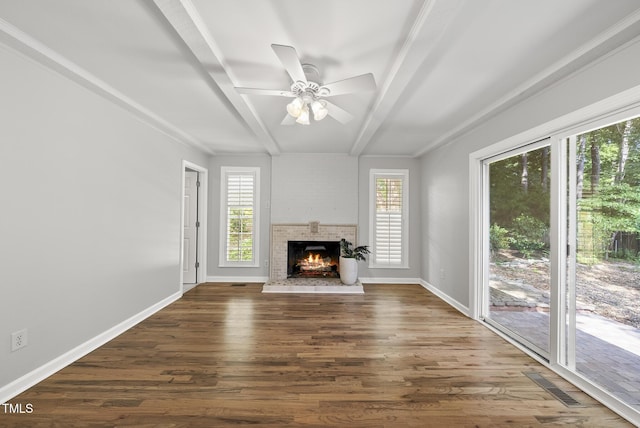 1201 Pond St, Cary, NC 27511 - unfurnished living room with beamed ceiling, dark wood-style floors, a ceiling fan, and a fireplace