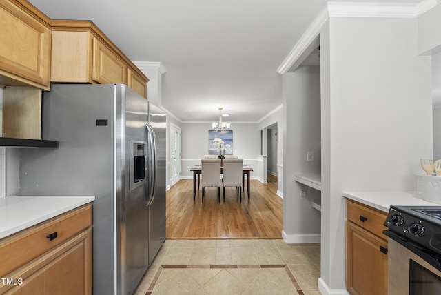 1201 Pond St, Cary, NC 27511 - kitchen featuring light tile patterned floors, appliances with stainless steel finishes, light countertops, a chandelier, and ornamental molding