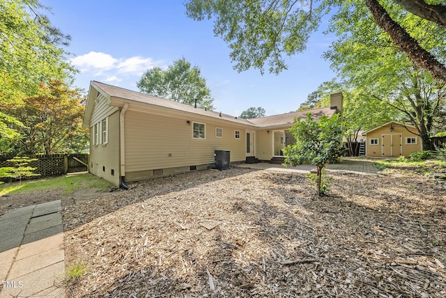1201 Pond St, Cary, NC 27511 - back of house featuring a storage unit, crawl space, a patio, and a chimney