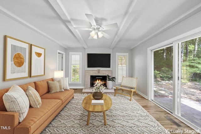 1201 Pond St, Cary, NC 27511 - living area featuring light wood-style flooring, beamed ceiling, ceiling fan, and a fireplace