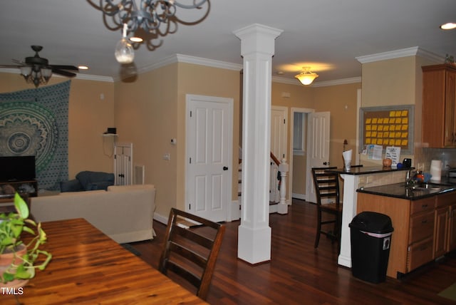 dining space with a ceiling fan, dark wood finished floors, ornate columns, ornamental molding, and baseboards