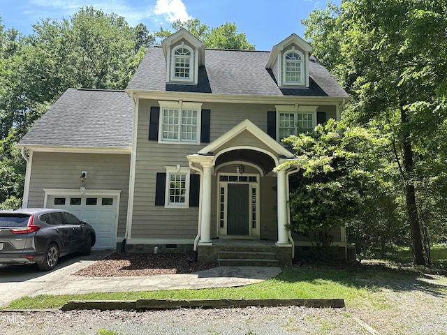 view of front of home featuring a garage, concrete driveway, and a shingled roof