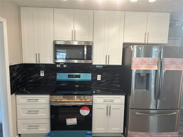 kitchen with appliances with stainless steel finishes, white cabinetry, and decorative backsplash