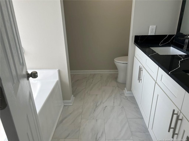 full bathroom featuring marble look tiles, toilet, vanity, baseboards, and a bath