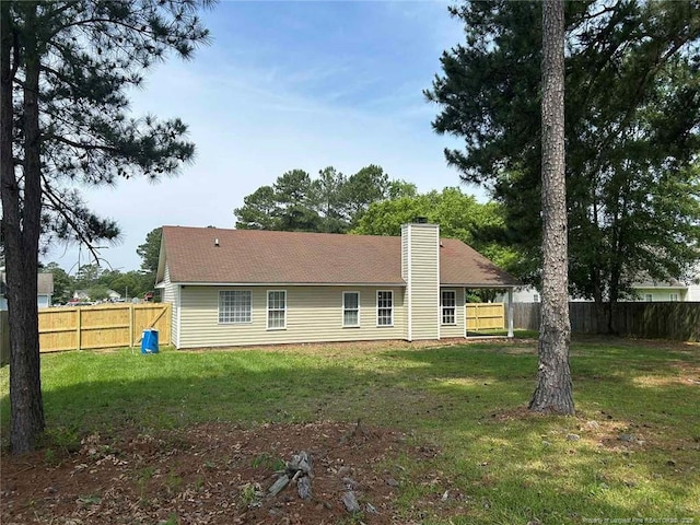 rear view of property with a chimney