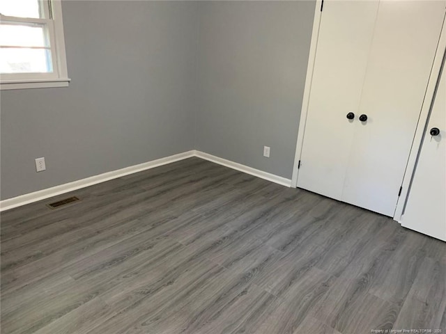 4212 Forest View Dr, Fayetteville, NC 28304 - unfurnished bedroom featuring dark wood-style floors, baseboards, and a closet